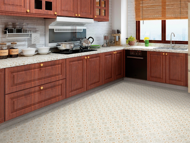 Patterned luxury vinyl tile floors draw the eye across a large kitchen with dark cabinets and marble countertops.